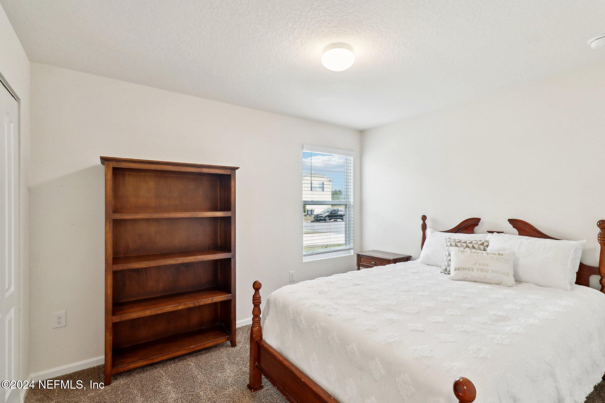 2535 Acorn Creek Road Green Cove Springs, FL 32043 - Photo 16 of 35 a bedroom with a bed and a closet