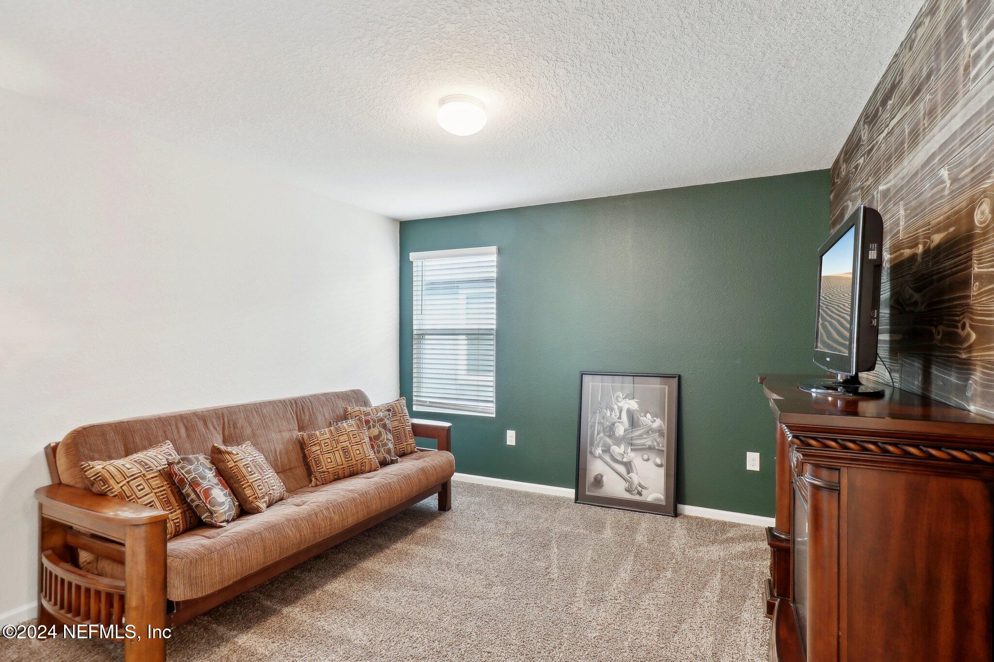 2535 Acorn Creek Road Green Cove Springs, FL 32043 - Photo 18 of 35 a living room with furniture and a fireplace