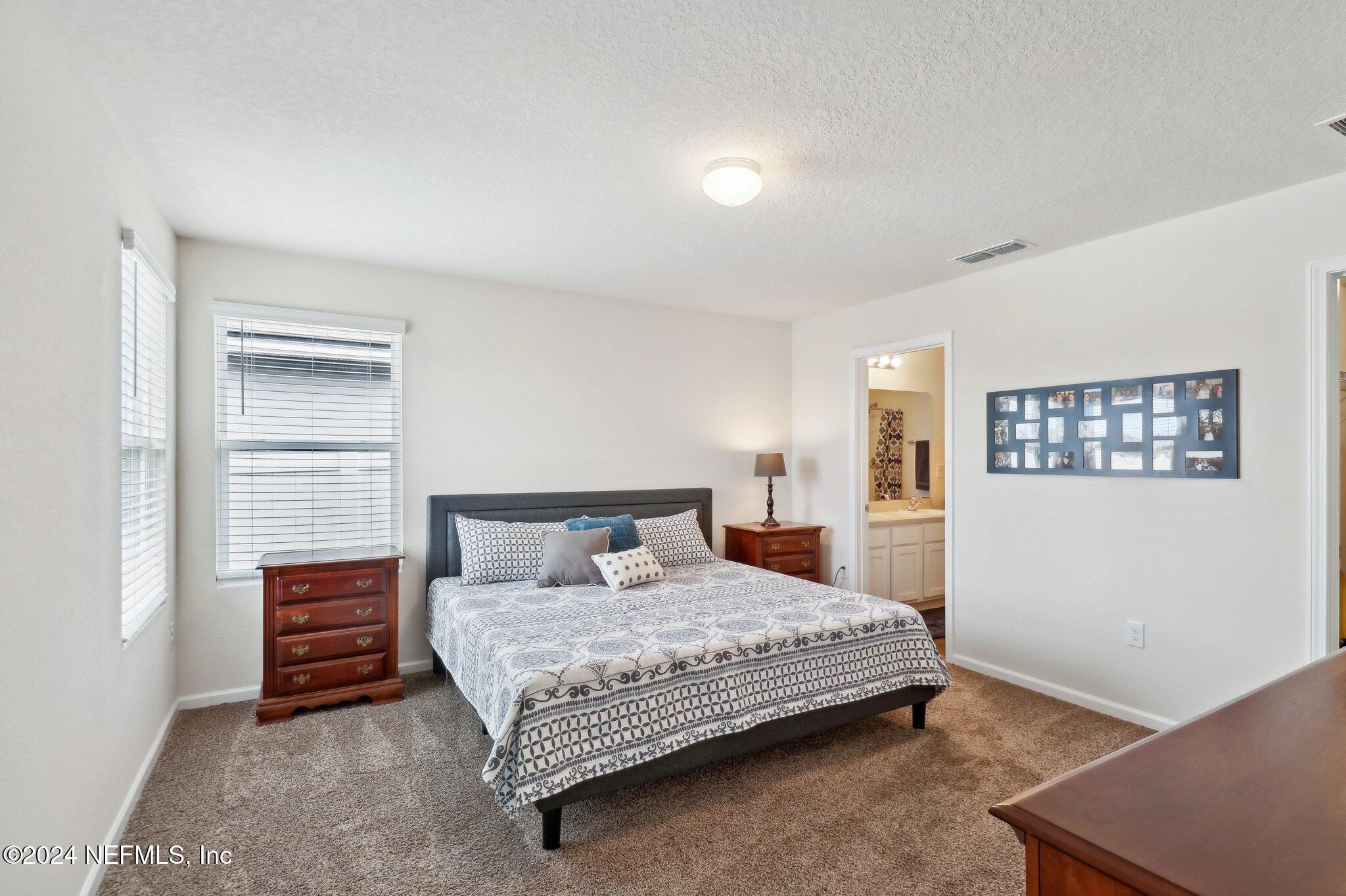 2535 Acorn Creek Road Green Cove Springs, FL 32043 - Photo 20 of 35 a bedroom with a bed and a window