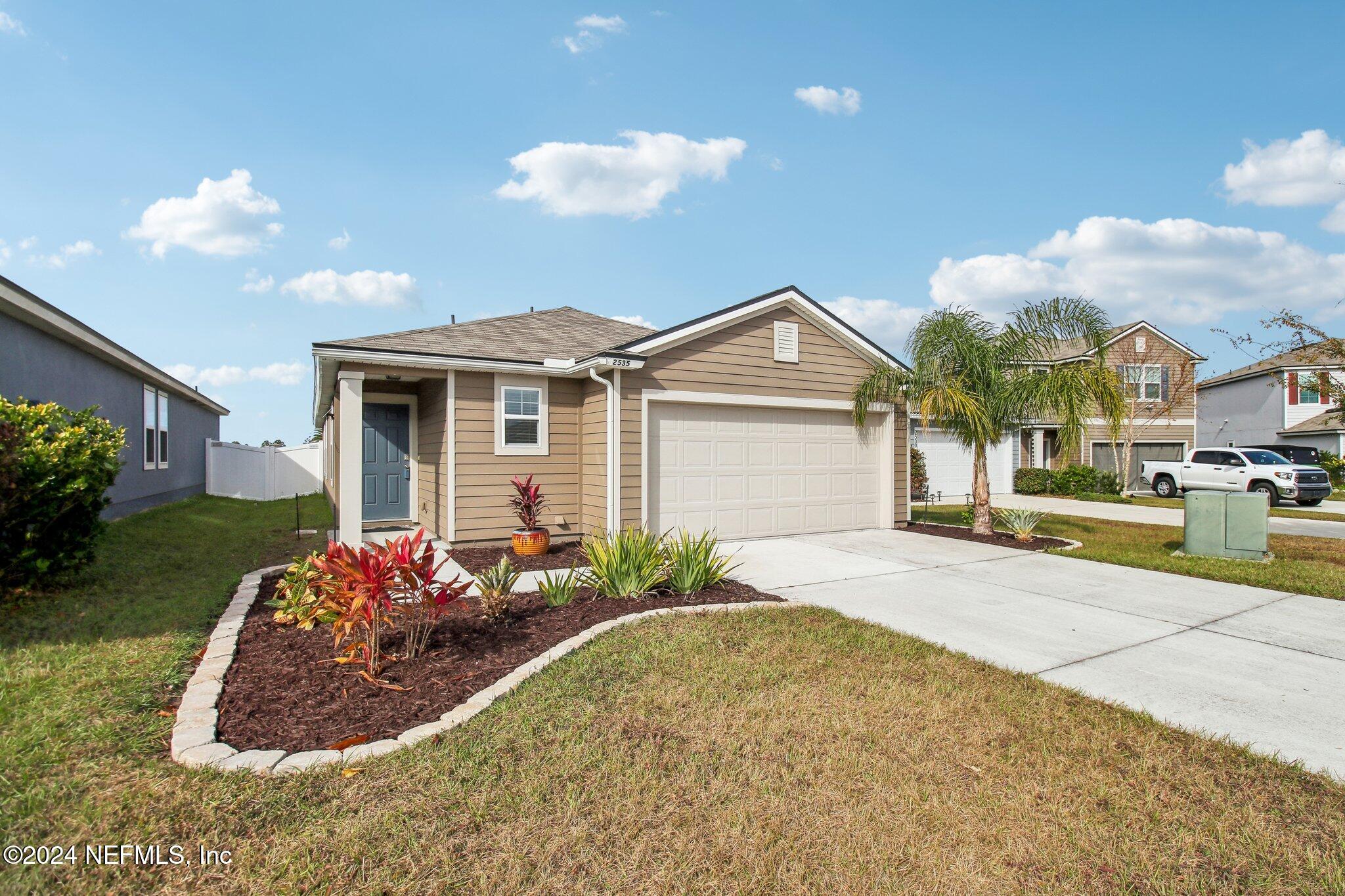 2535 Acorn Creek Road Green Cove Springs, FL 32043 - Photo 2 of 35 a front view of a house with garden