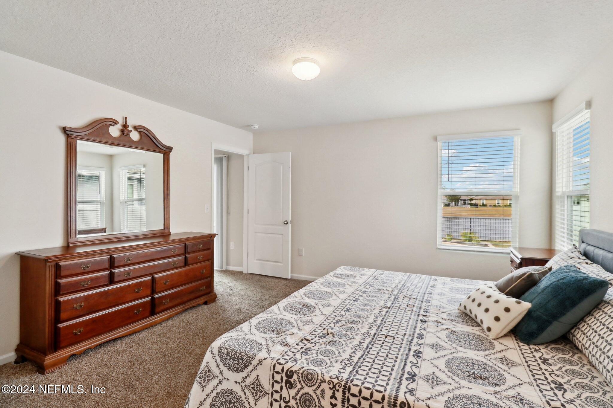 2535 Acorn Creek Road Green Cove Springs, FL 32043 - Photo 22 of 35 a bedroom with a bed and a dresser
