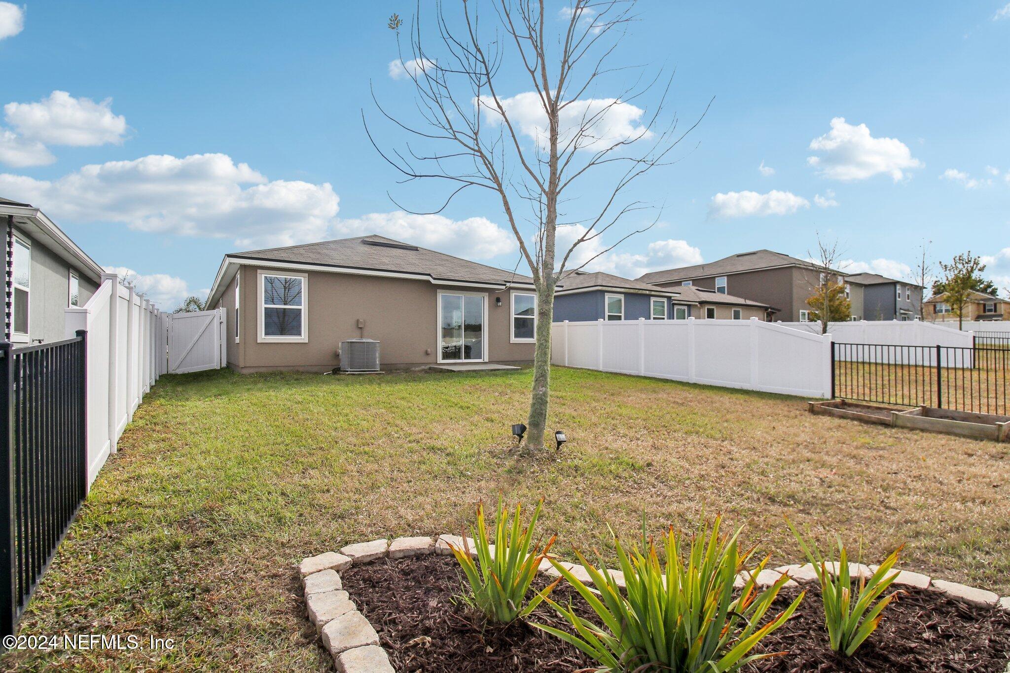 2535 Acorn Creek Road Green Cove Springs, FL 32043 - Photo 26 of 35 a large white house with a large pool in front of it