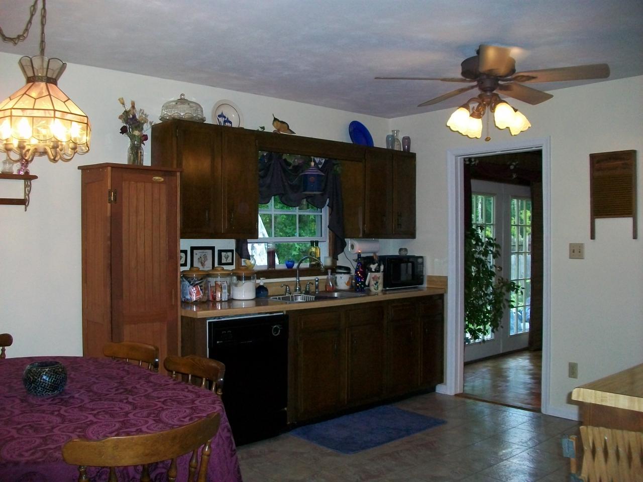 4336 Union Church Road Thaxton, VA 24174 - Photo 6 of 9 a kitchen with stainless steel appliances granite countertop a refrigerator a sink dishwasher a dining table and chairs with wooden floor