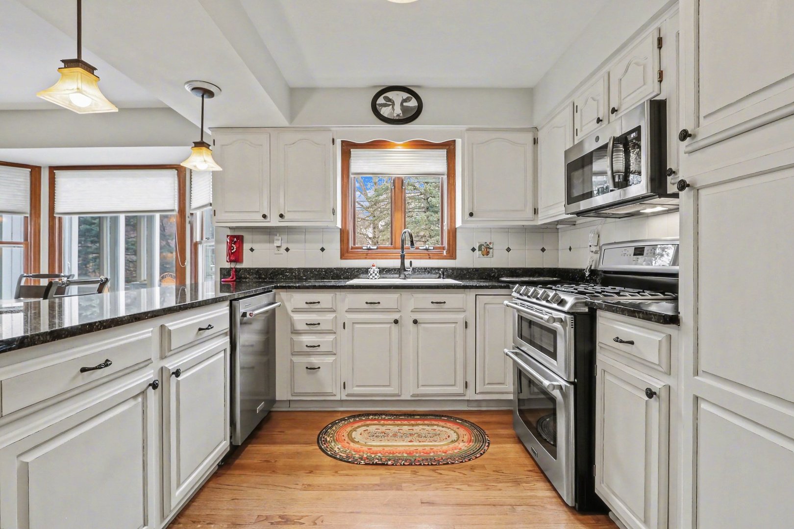 570 Violet Lane Batavia, IL 60510 - Photo 11 of 28 a kitchen with stainless steel appliances granite countertop a stove a sink and a refrigerator