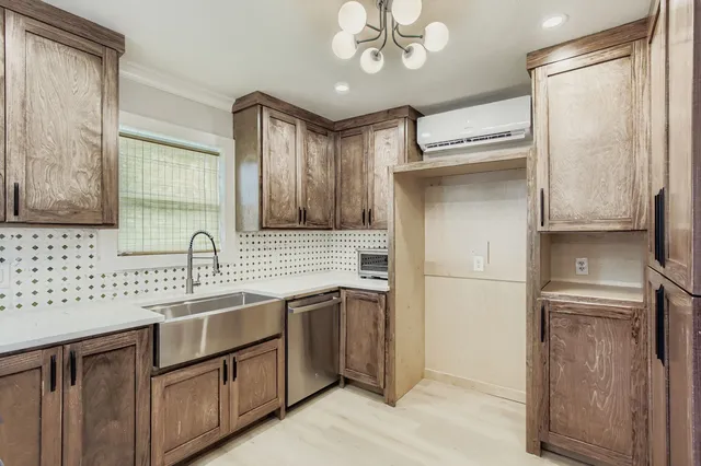 a kitchen with a sink refrigerator and cabinets
