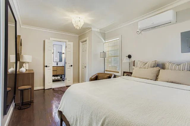 a bedroom with a bed and a chair