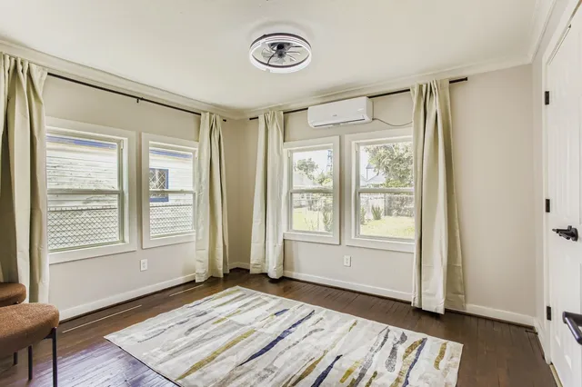 a view of a livingroom with wooden floor and a window