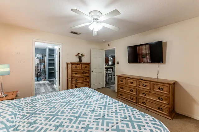 a bedroom with a bed and flat screen tv