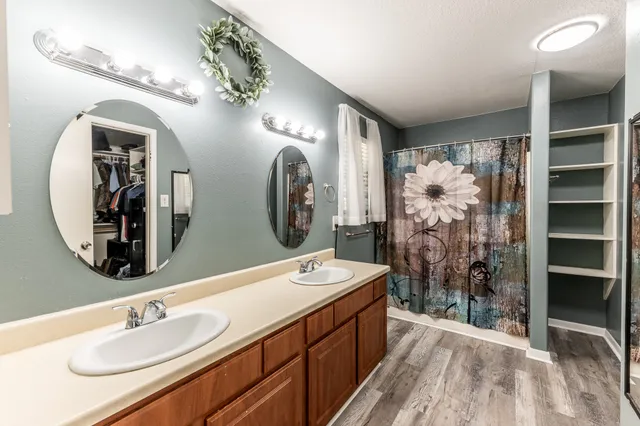 a bathroom with a double vanity sink and a mirror