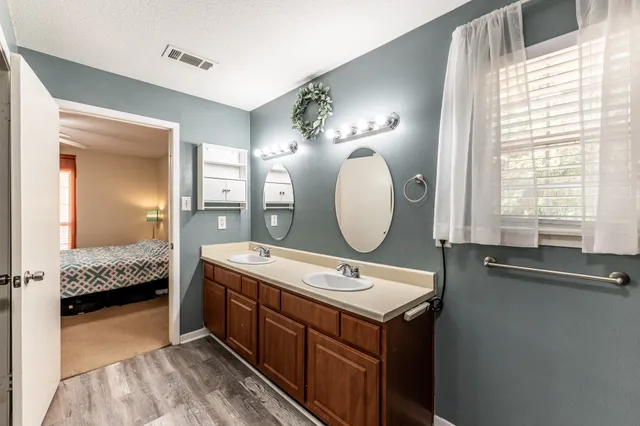 a bathroom with a double vanity sink and a mirror