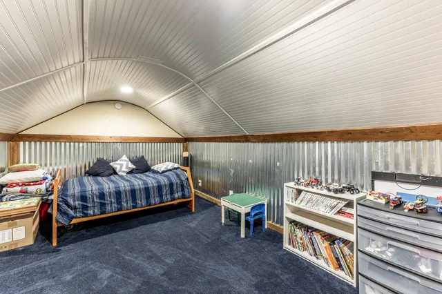 a bedroom with furniture and a baby crib