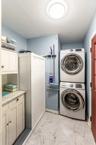 a utility room with sink washer and dryer