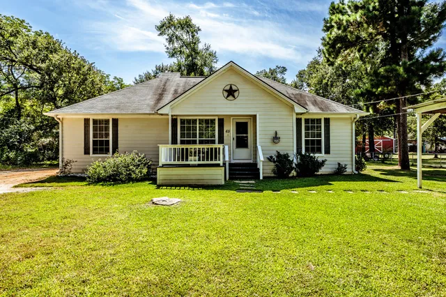 a view of a house with swimming pool and a yard
