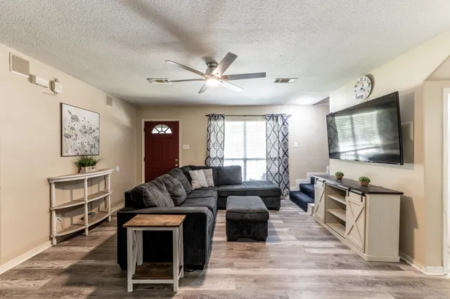 a living room with furniture and a flat screen tv