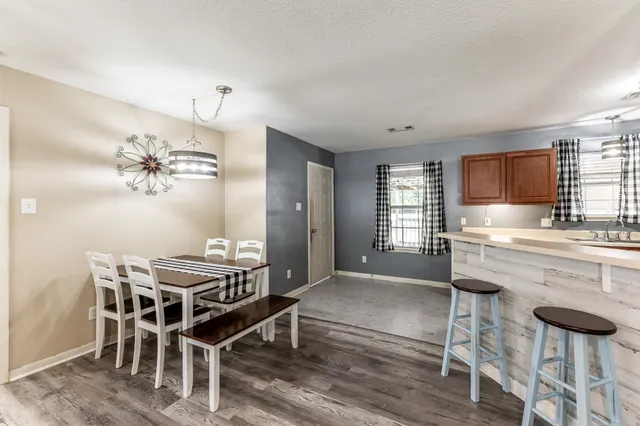 a kitchen with granite countertop counter space dining table and stainless steel appliances