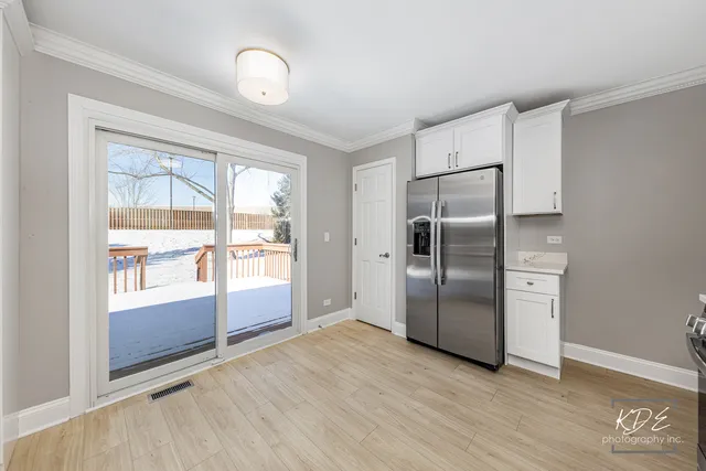 an empty room with wooden floor and ceiling fan