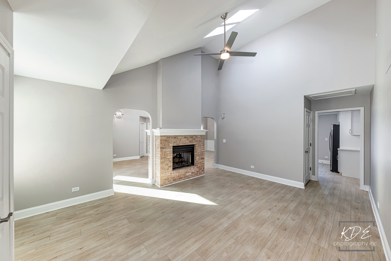 3027 Brossman Street Naperville, IL 60564 - Photo 12 of 42 an empty room with wooden floor fireplace and chandelier