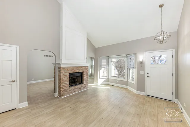 a kitchen with granite countertop a refrigerator and a stove top oven