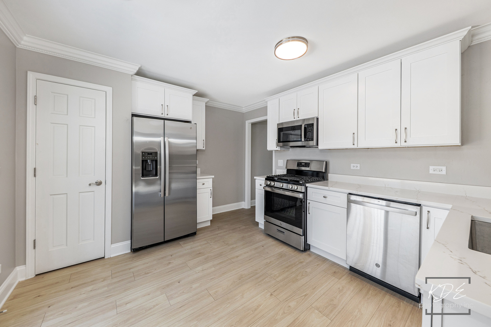 3027 Brossman Street Naperville, IL 60564 - Photo 8 of 42 a kitchen with granite countertop a refrigerator and a stove top oven