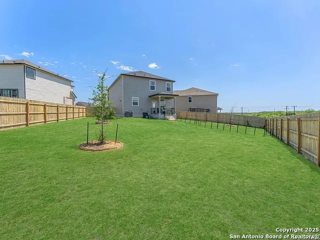 a backyard of a house with table and chairs
