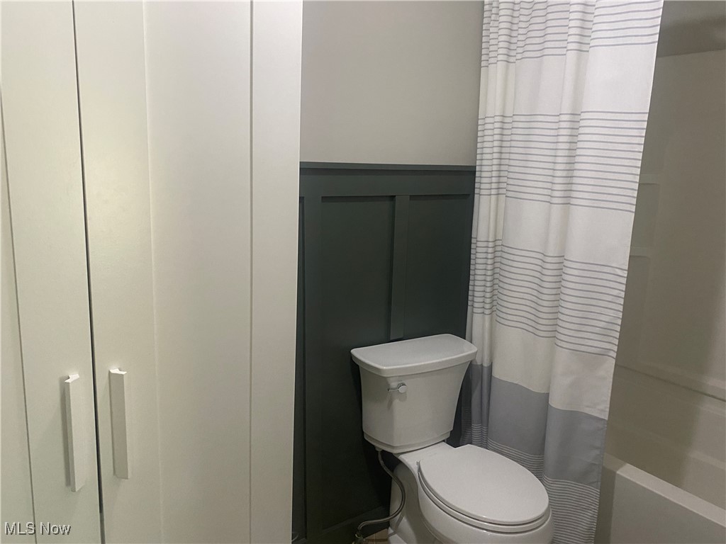 3016 Wadsworth Road Norton, OH 44203 - Photo 33 of 50 Bathroom with toilet and shower / tub combo with curtain
