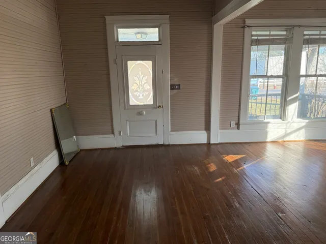 a view of a livingroom with wooden floor and a window