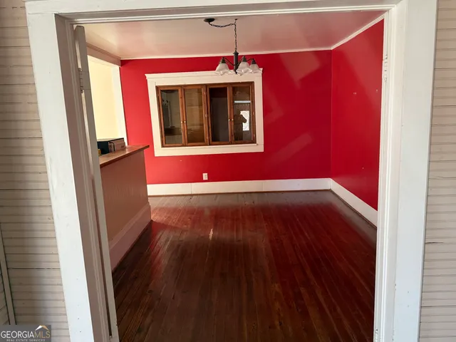 a view of an entryway with wooden floor