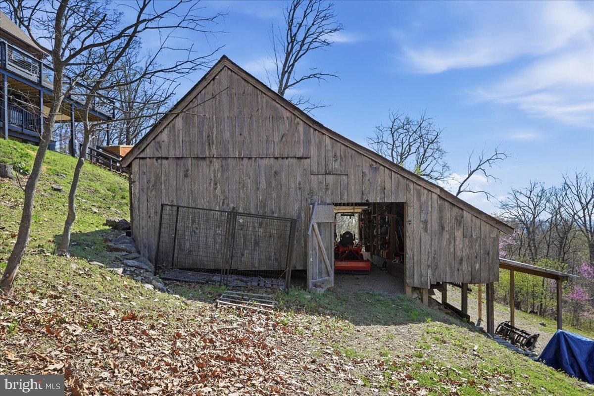 19897 Foresthill Road Bluemont, VA 20135 - Photo 25 of 39 a view of a small barn with wooden fence
