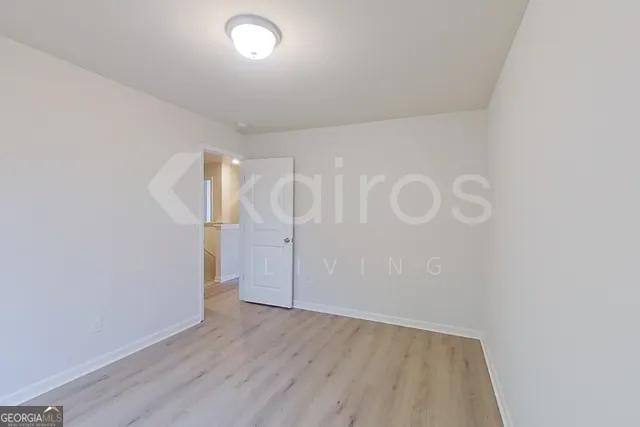 a view of an empty room with wooden floor