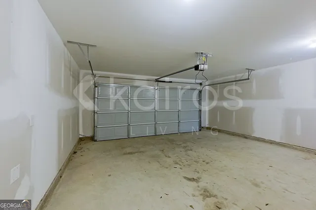 an empty room with white walls and windows