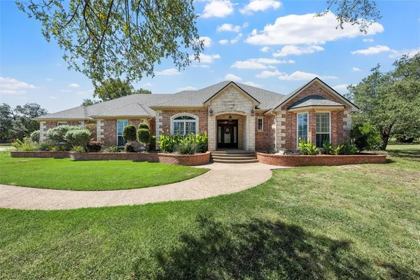 a front view of a house with a yard
