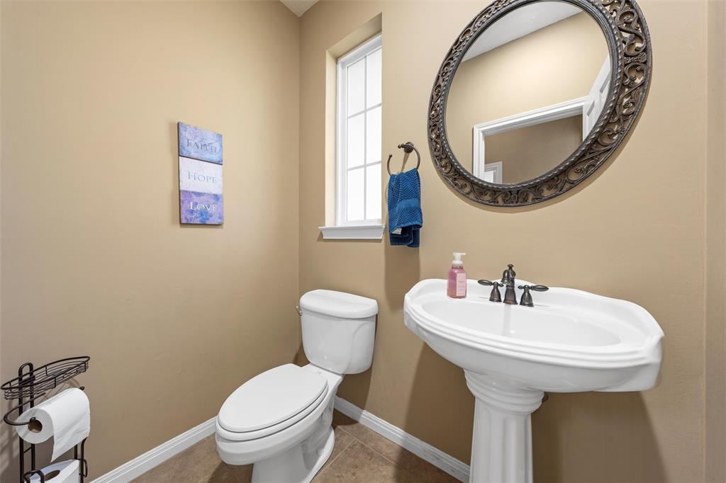 175 Winding Trail Crawford, TX 76638 - Photo 18 of 40 a bathroom with a toilet a sink and a mirror