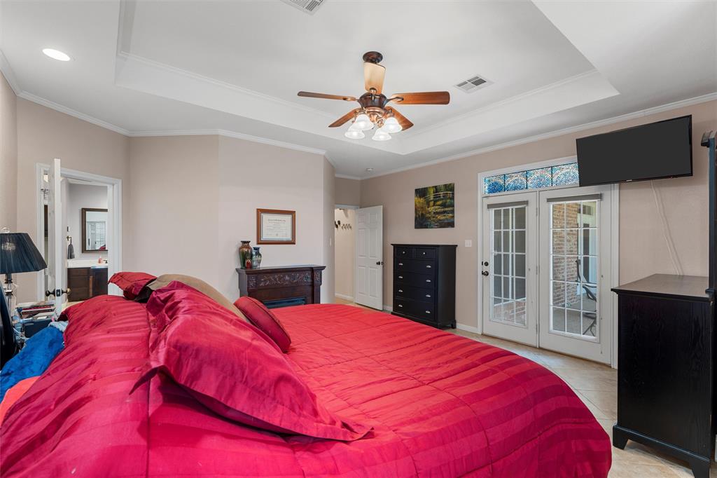 175 Winding Trail Crawford, TX 76638 - Photo 20 of 40 a bedroom with a large bed and a flat tv screen