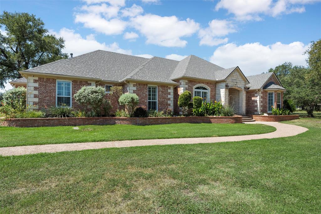 175 Winding Trail Crawford, TX 76638 - Photo 2 of 40 a front view of a house with a yard