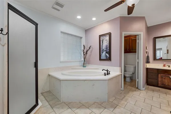 a bathroom with a tub sink and mirror