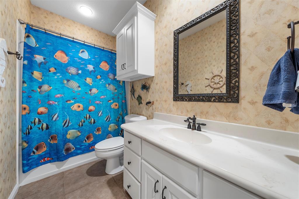 175 Winding Trail Crawford, TX 76638 - Photo 26 of 40 a bathroom with a sink and a mirror