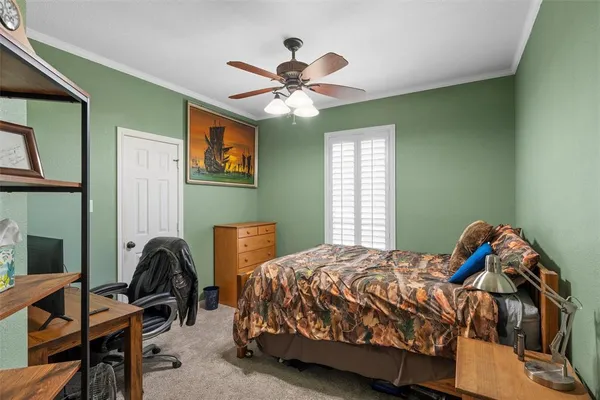a bedroom with a large bed and a chandelier