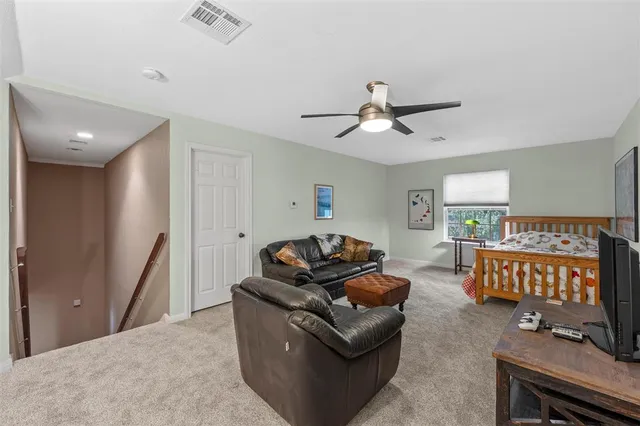 a bedroom with bed couch and window