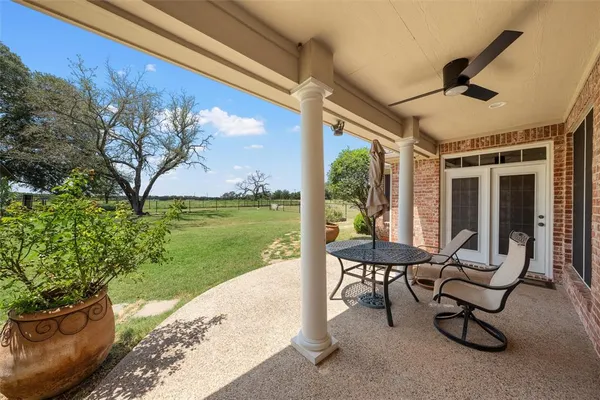 a view of a house with backyard and sitting area
