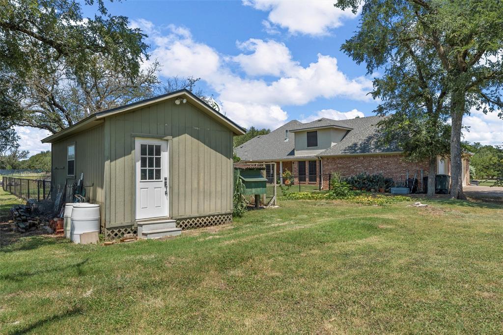 175 Winding Trail Crawford, TX 76638 - Photo 37 of 40 a front view of a house with a garden