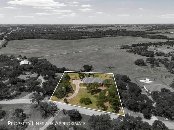 an aerial view of a house with a lake