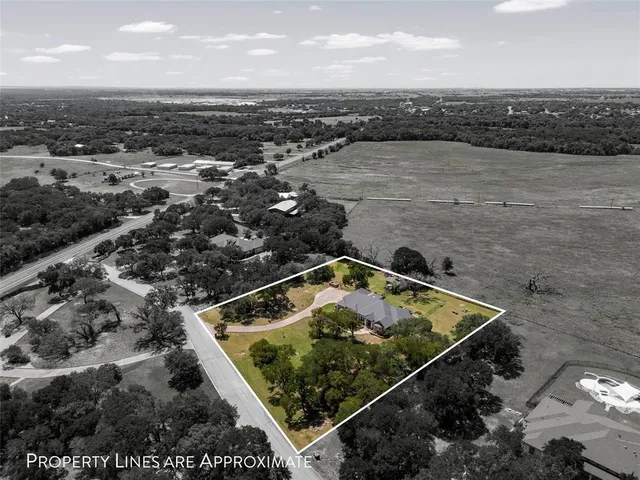 an aerial view of house with yard