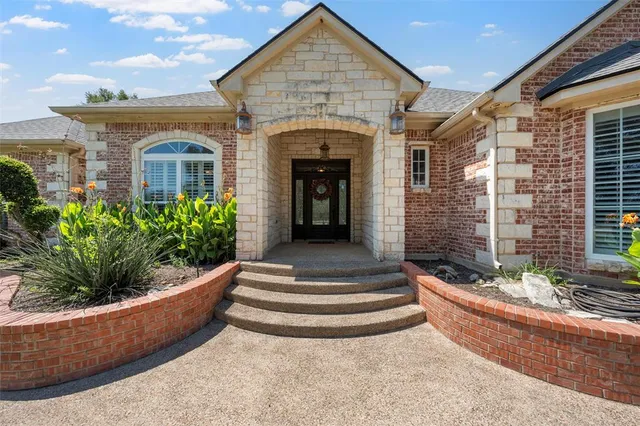 a view of a house with potted plants
