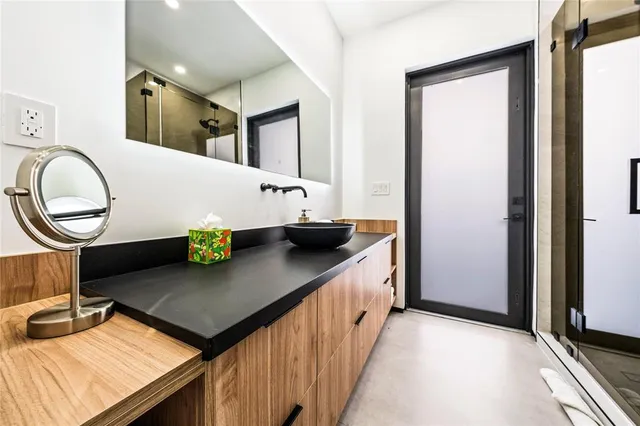 a view of kitchen island with stainless steel appliances granite countertop a sink and a refrigerator