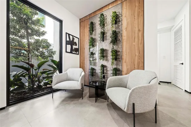 a living room with furniture and a large window with outer view