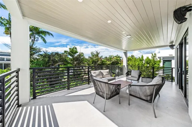 a balcony with furniture and a potted plant