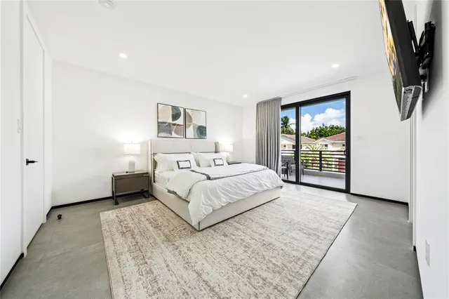 a bedroom with a large bed and a flat screen tv