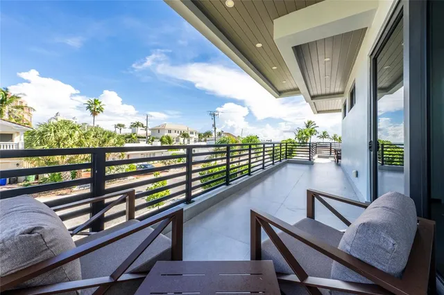 a view of a chairs and table in the balcony