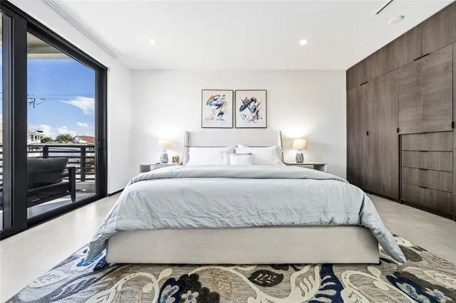 a bedroom with a bed and glass walk in closet