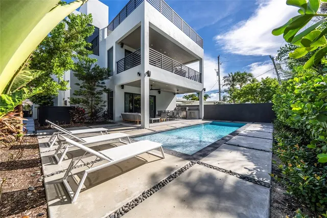 a view of a house with backyard and sitting area